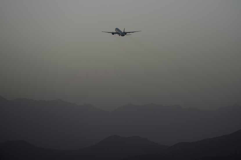 A Qatar Airways aircraft takes off with foreigners from the airport in Kabul, Afghanistan,...