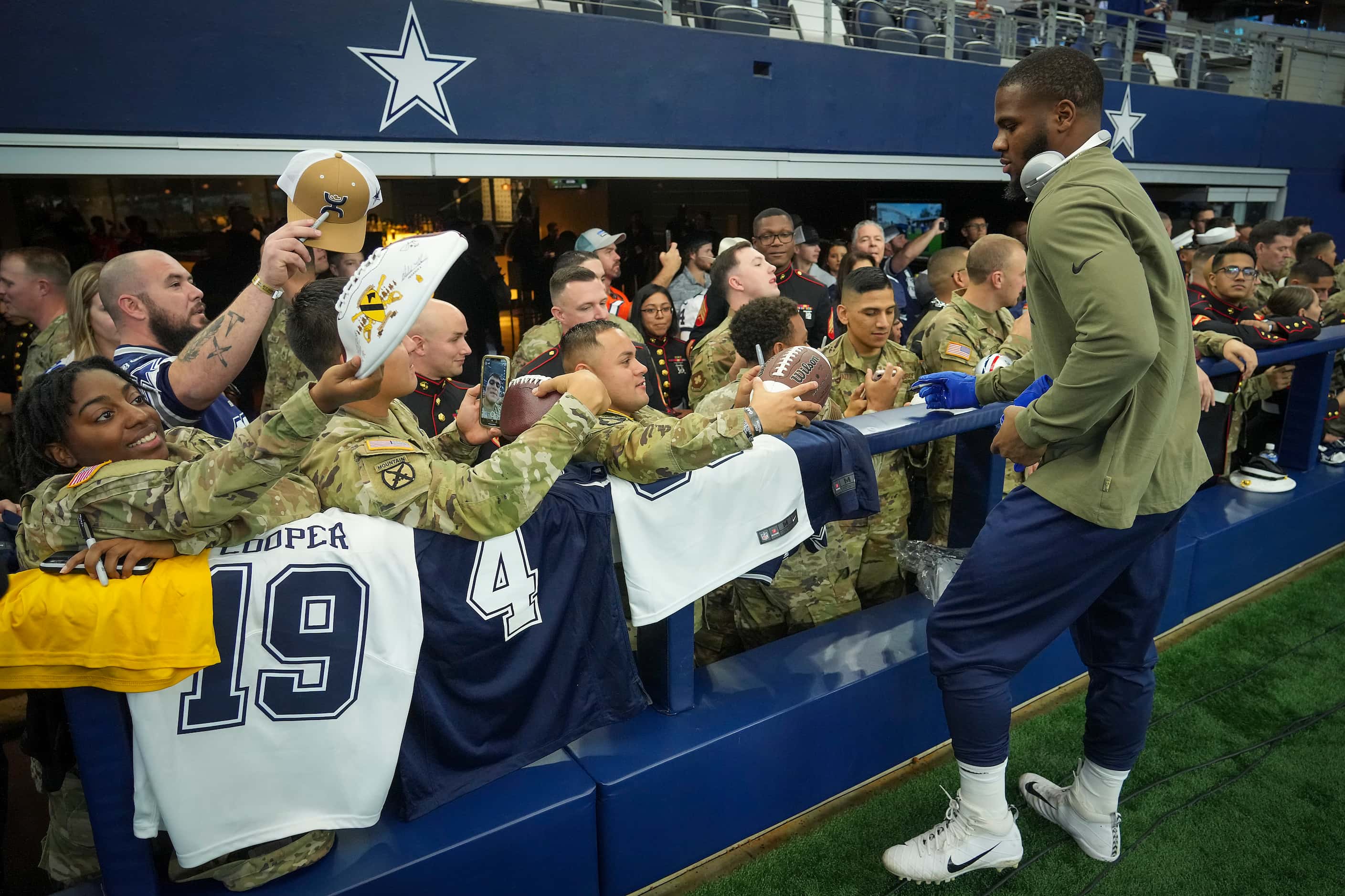 Dallas Cowboys outside linebacker Micah Parsons signs autographs for a group of service...