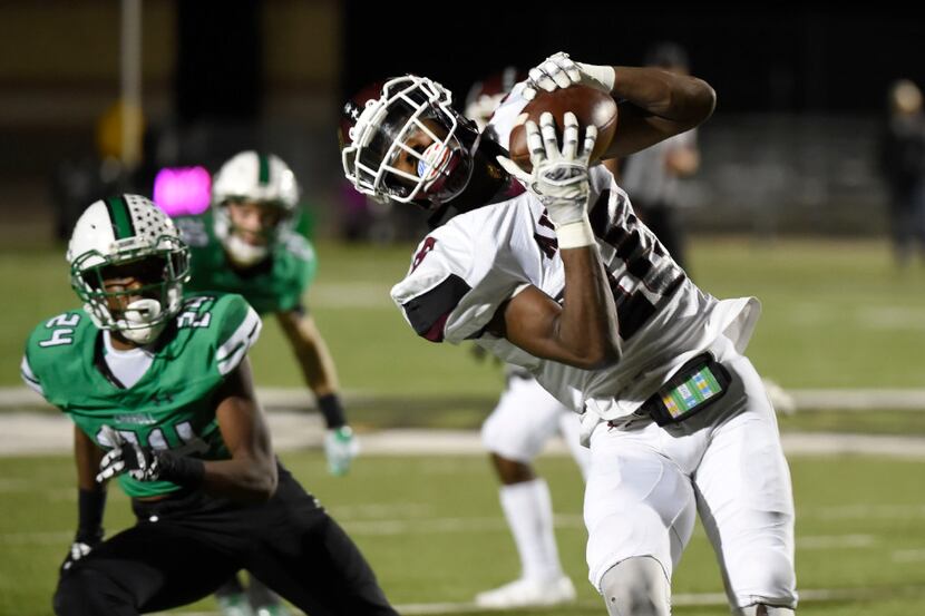 Wylie's Donovan Ollie (18) makes a reception in front of Southlake's  RJ Mickens (24) during...