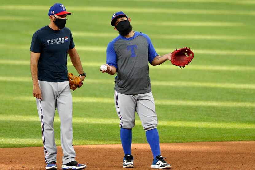 Texas Rangers manager Chris Woodward talks with Texas Rangers Rougned Odor (12) during Texas...