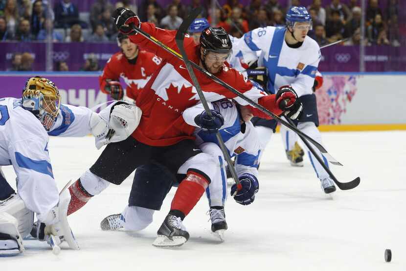 Canada forward Benn Jamie (22) scrambles against Finland defenseman Juuso Hietanen in the...
