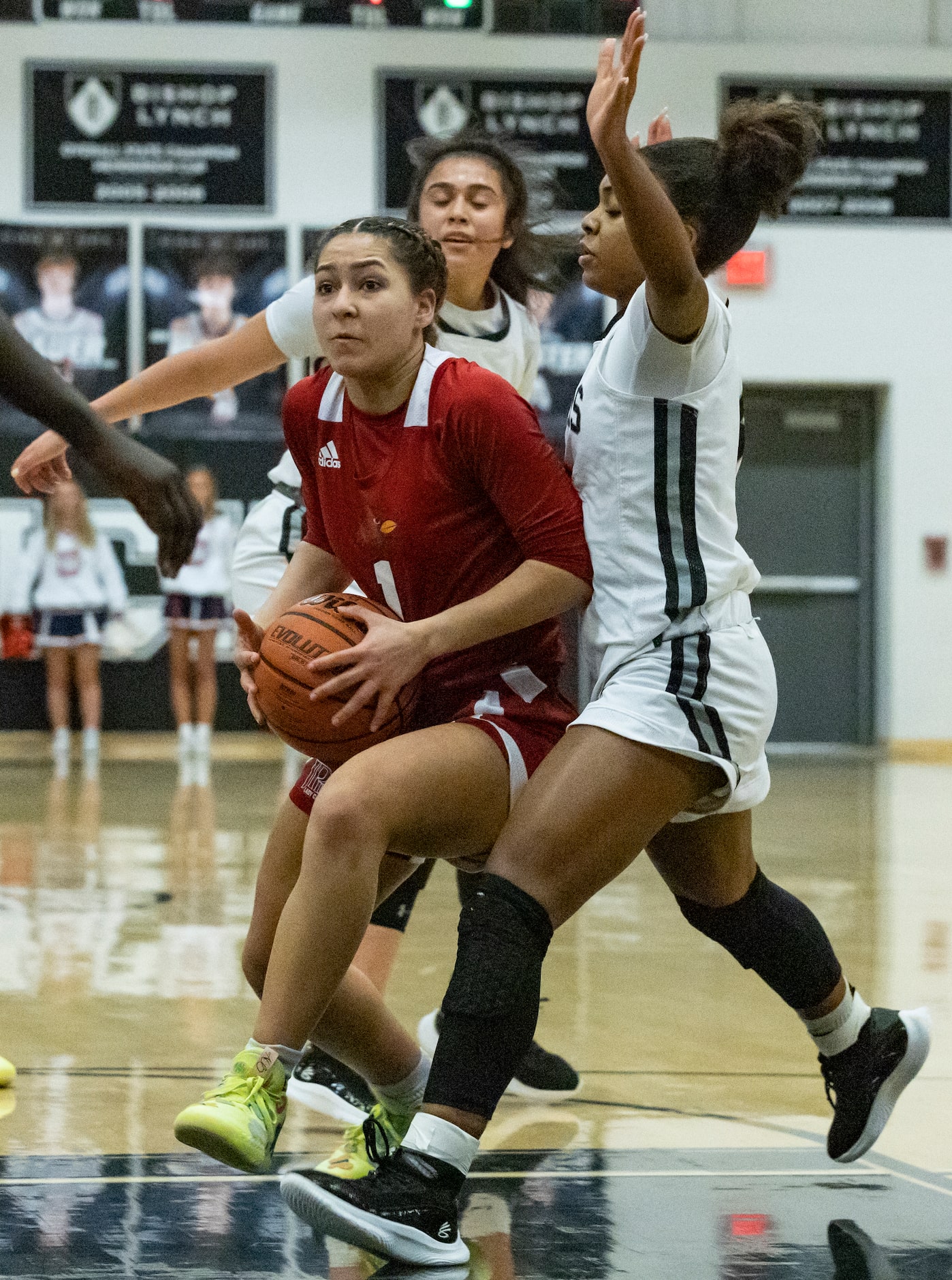 John Paul II High School Alana Goosby (1) pushes past Bishop Lynch High School Maddie...