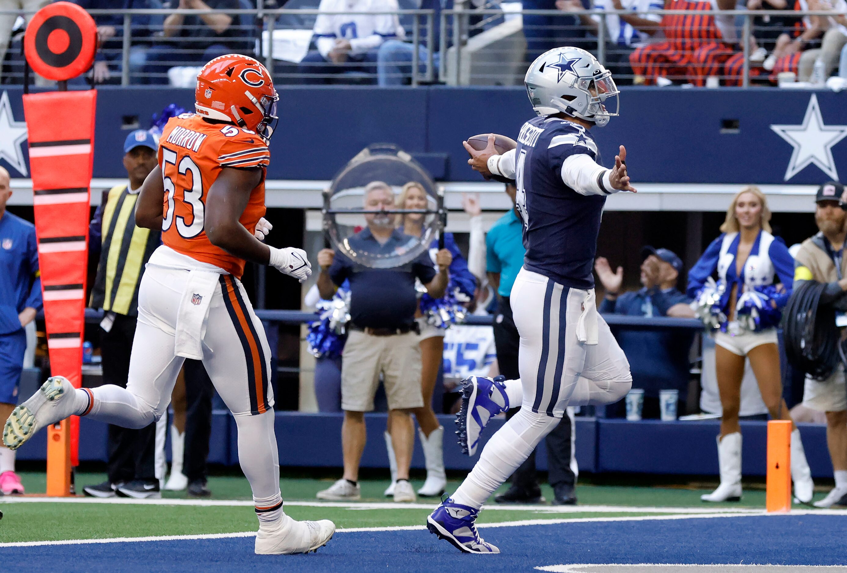 Dallas Cowboys quarterback Dak Prescott (4) throws out his arms as he runs in a first...