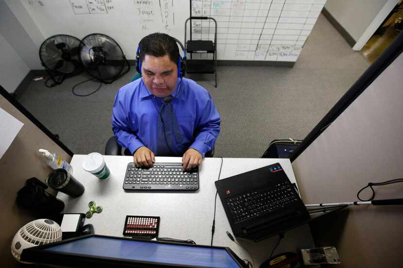 Al Rodriguez works at his desk in the call center at Bold Sales Solutions, a subsidiary of...