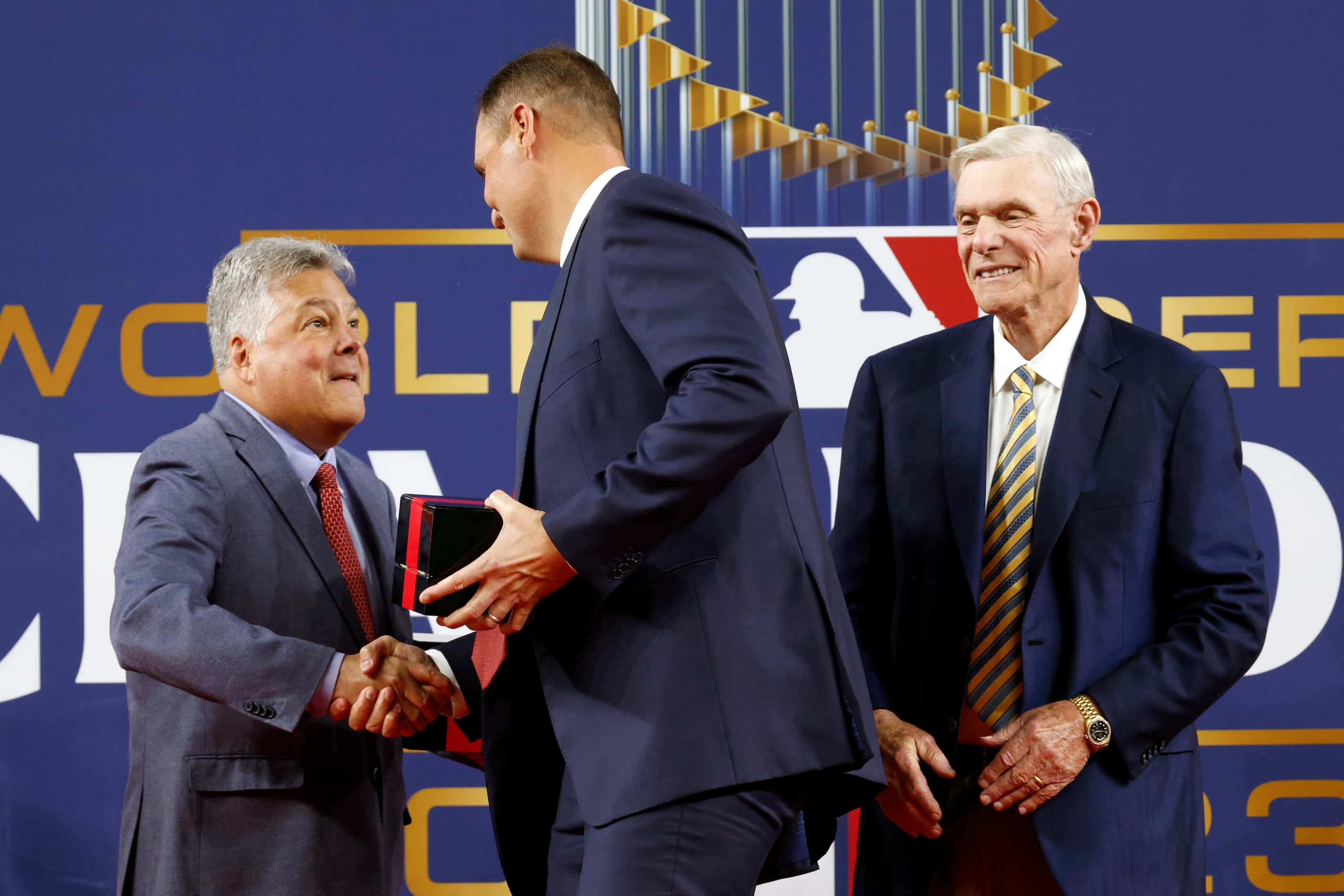 Neil Leibman, Texas Rangers president of business operations, shakes hands with general...