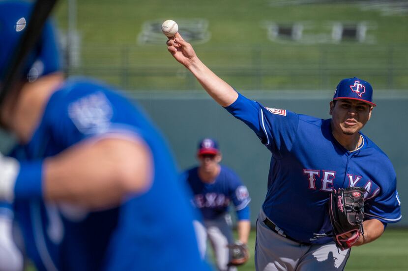 Texas Rangers pitcher Ariel Jurado pitches to Kansas City Royals left fielder Alex Gordon...