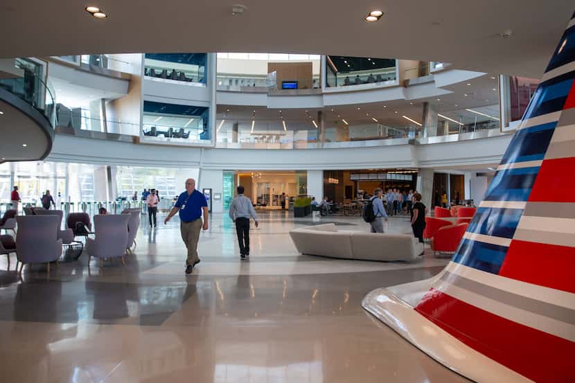 Employees walk through the main lobby of the Skyview 8 building at the new American Airlines...