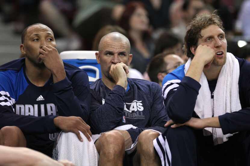 Dallas' (from left) Shawn Marion, Jason Kidd and Dirk Nowitzki wear the score on their faces...