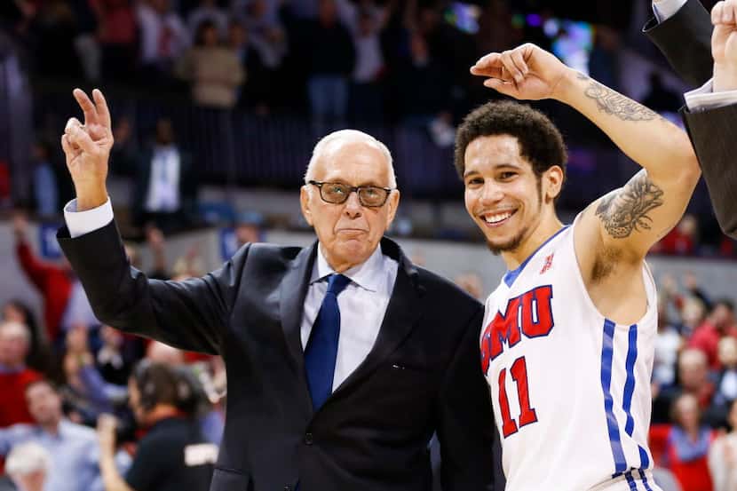SMU coach Larry Brown and guard Nic Moore (11) celebrate during SMU's alma mater following...