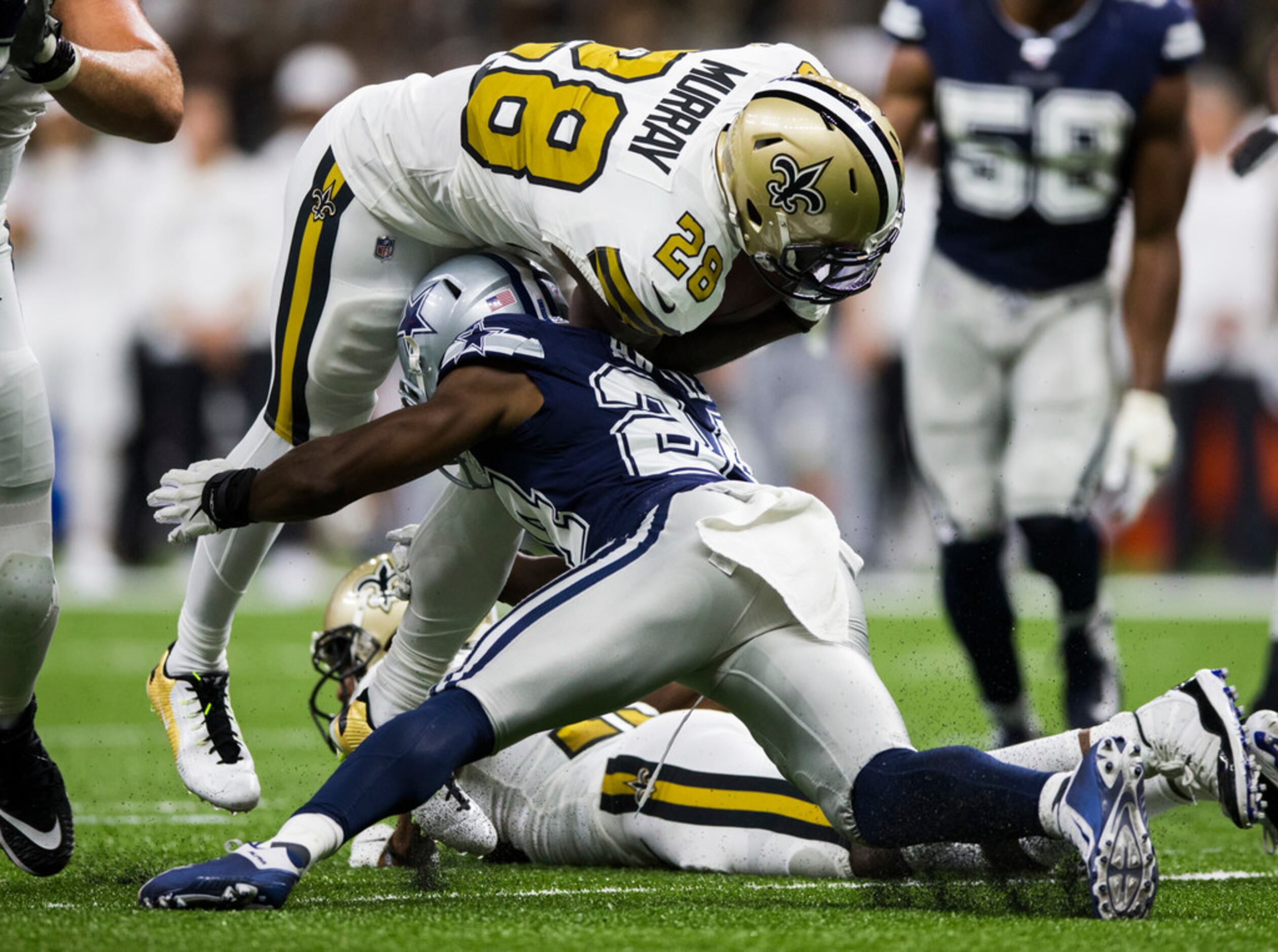 Dallas Cowboys cornerback Chidobe Awuzie (24) tackles New Orleans Saints running back...