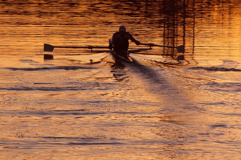 A rower moves across Bachman Lake in Dallas at sunset on Feb. 7, 2018. The lake is a...