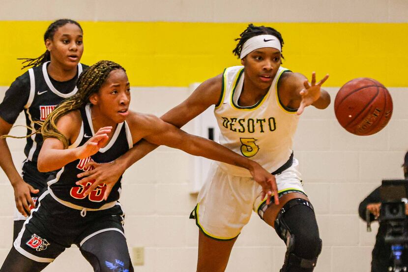 DeSoto's Sa'Myah Smith (5) tries to recover the ball from Duncanville's Nyah Wilson (33)...