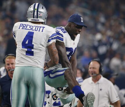 Dallas Cowboys quarterback Dak Prescott (4) celebrates with wide receiver Dez Bryant (88)...