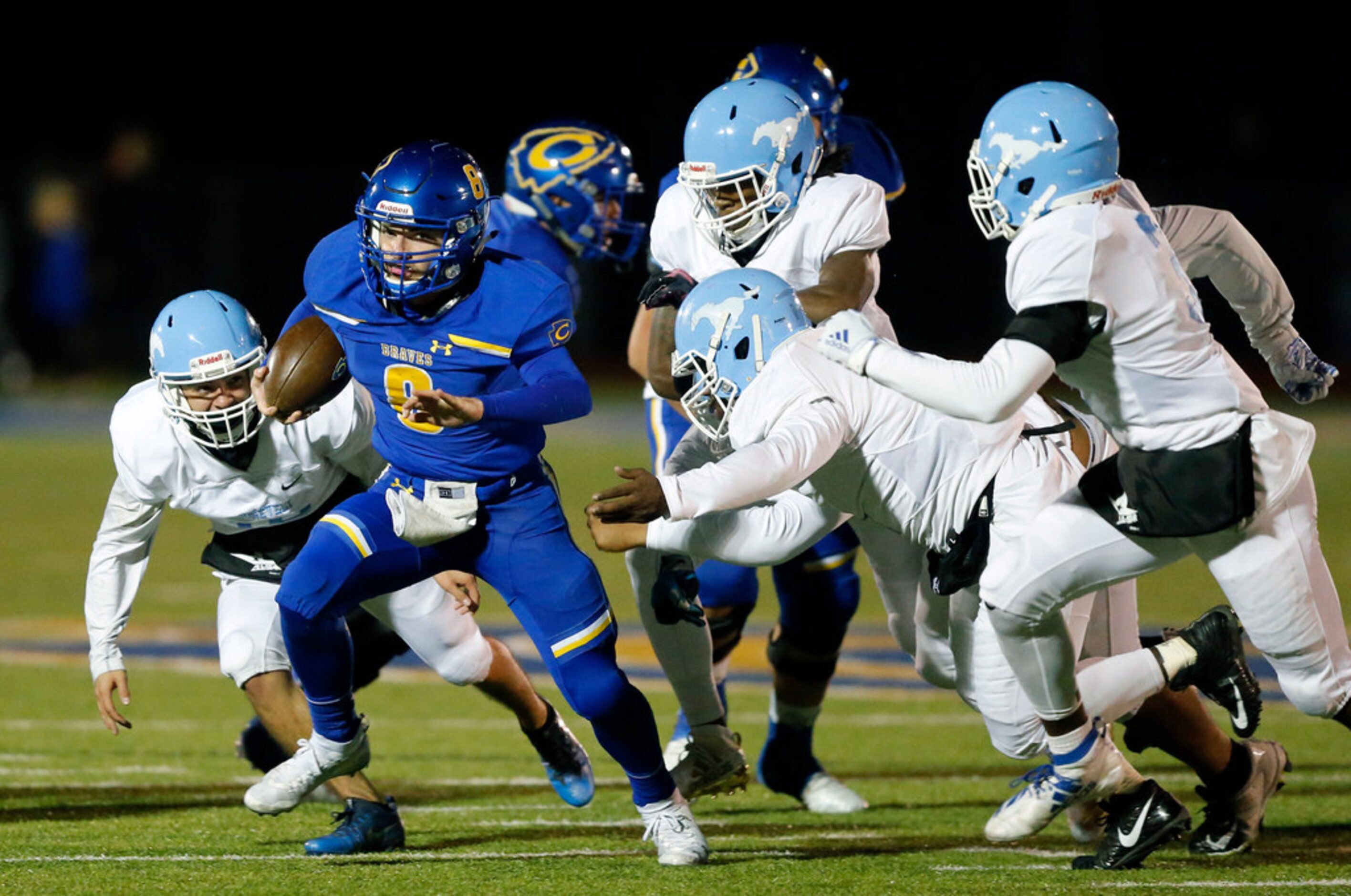 Community High quarterback Parker Simpson (8) eludes the Dallas Roosevelt defense during a...