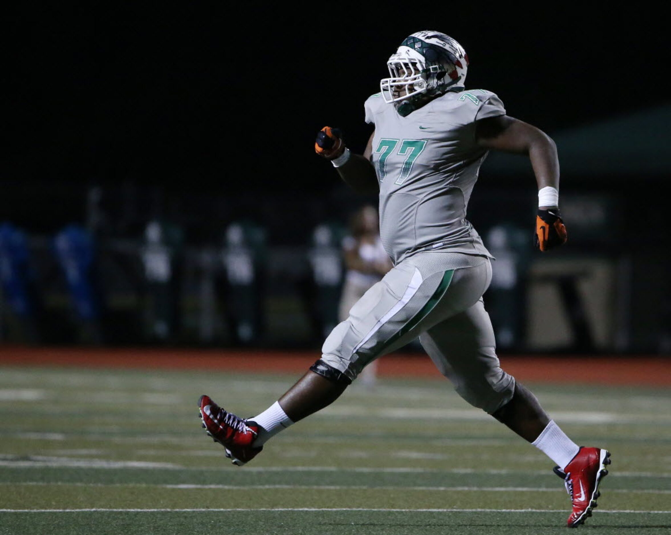 Waxahachie defensive lineman Randon Haynes (77) celebrates after he and defensive lineman...