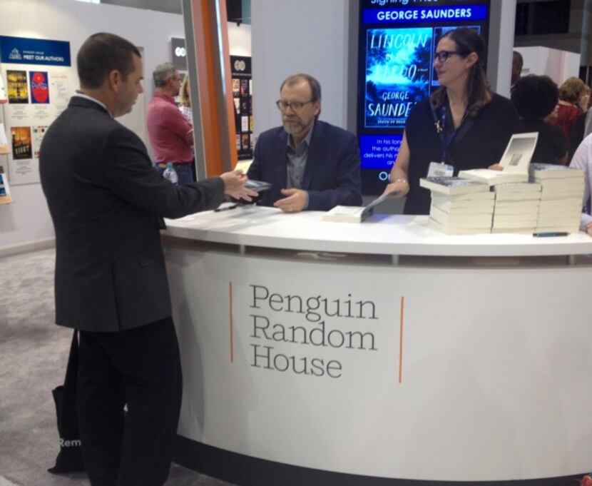  George Saunders signs advance copies of "Lincoln in the Bardo" at BookExpo America.