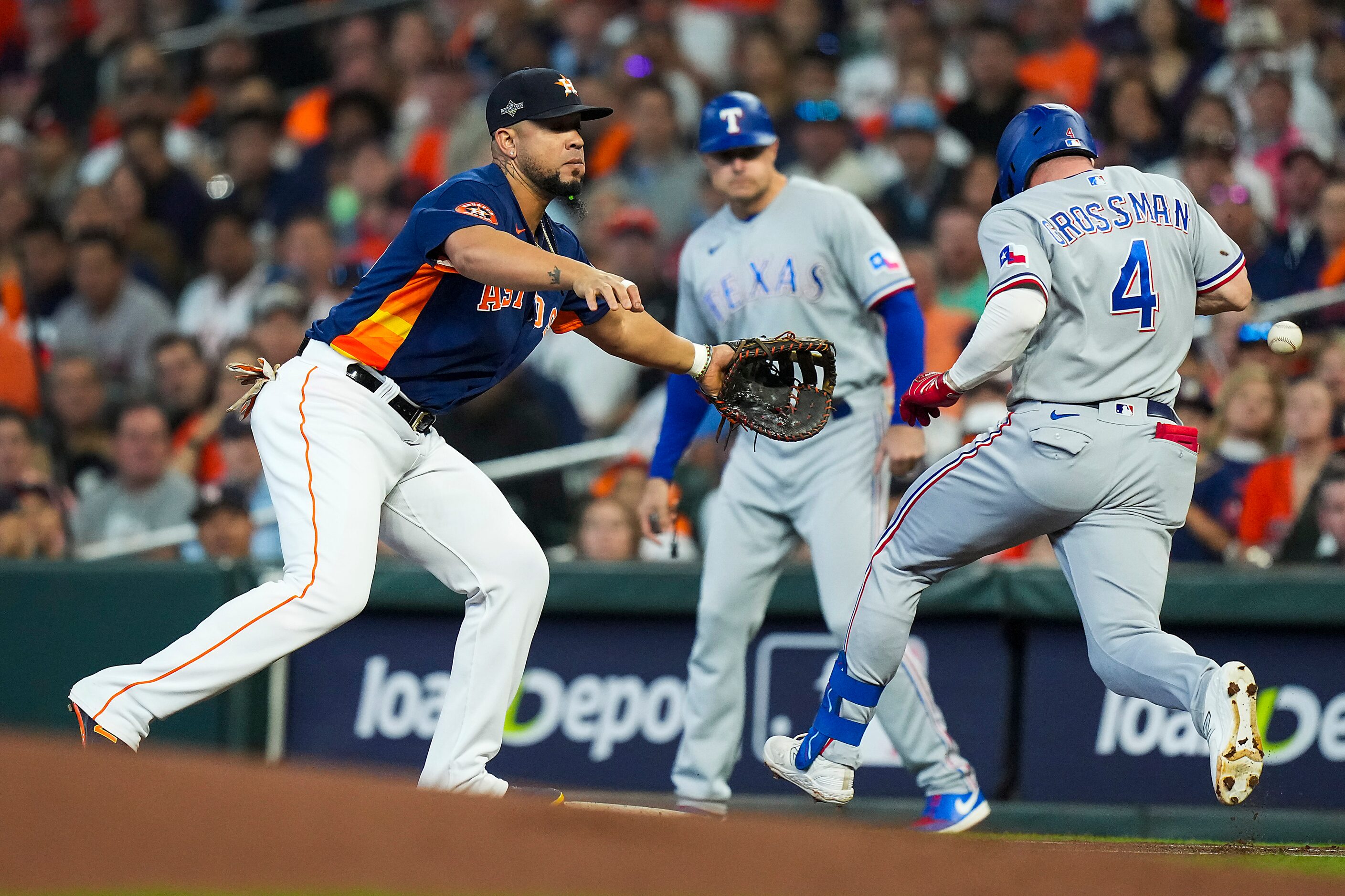 Texas Rangers left fielder Robbie Grossman (4) reaches first base on an error by Houston...