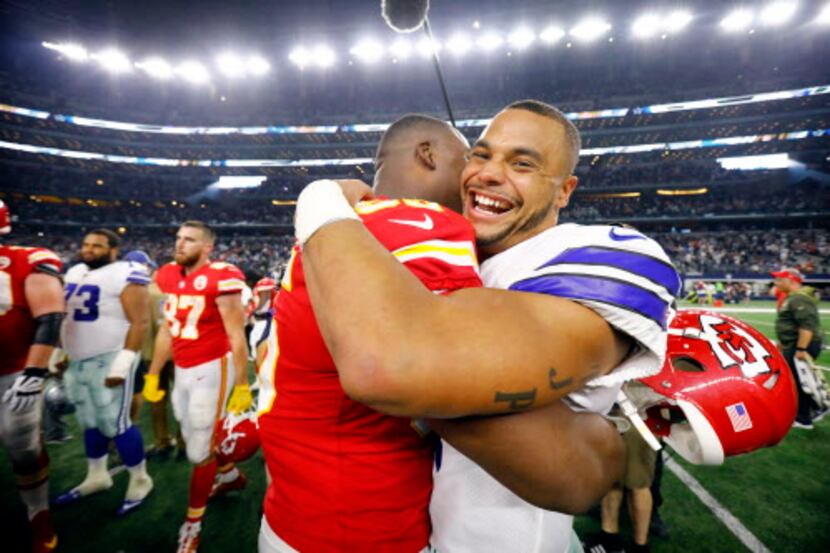 FILE - Cowboys quarterback Dak Prescott (4) hugs Chiefs defensive end Chris Jones, his...