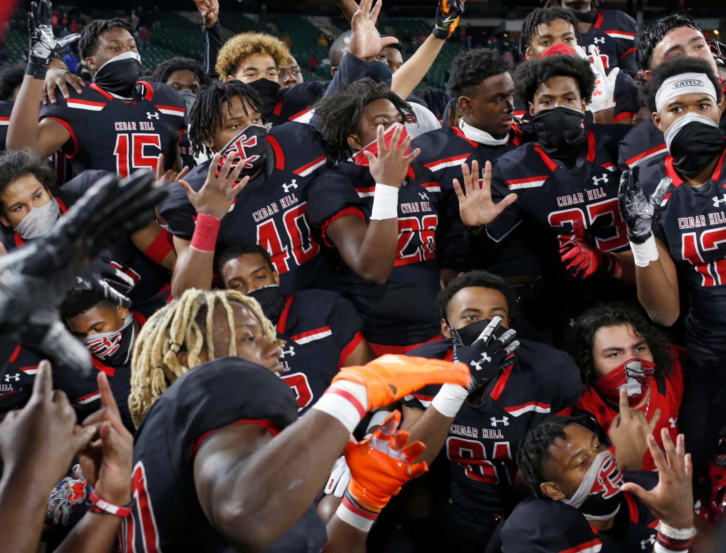 Cedar Hill Longhorns players pose for throngs of cameras following their 27-24 overtime...