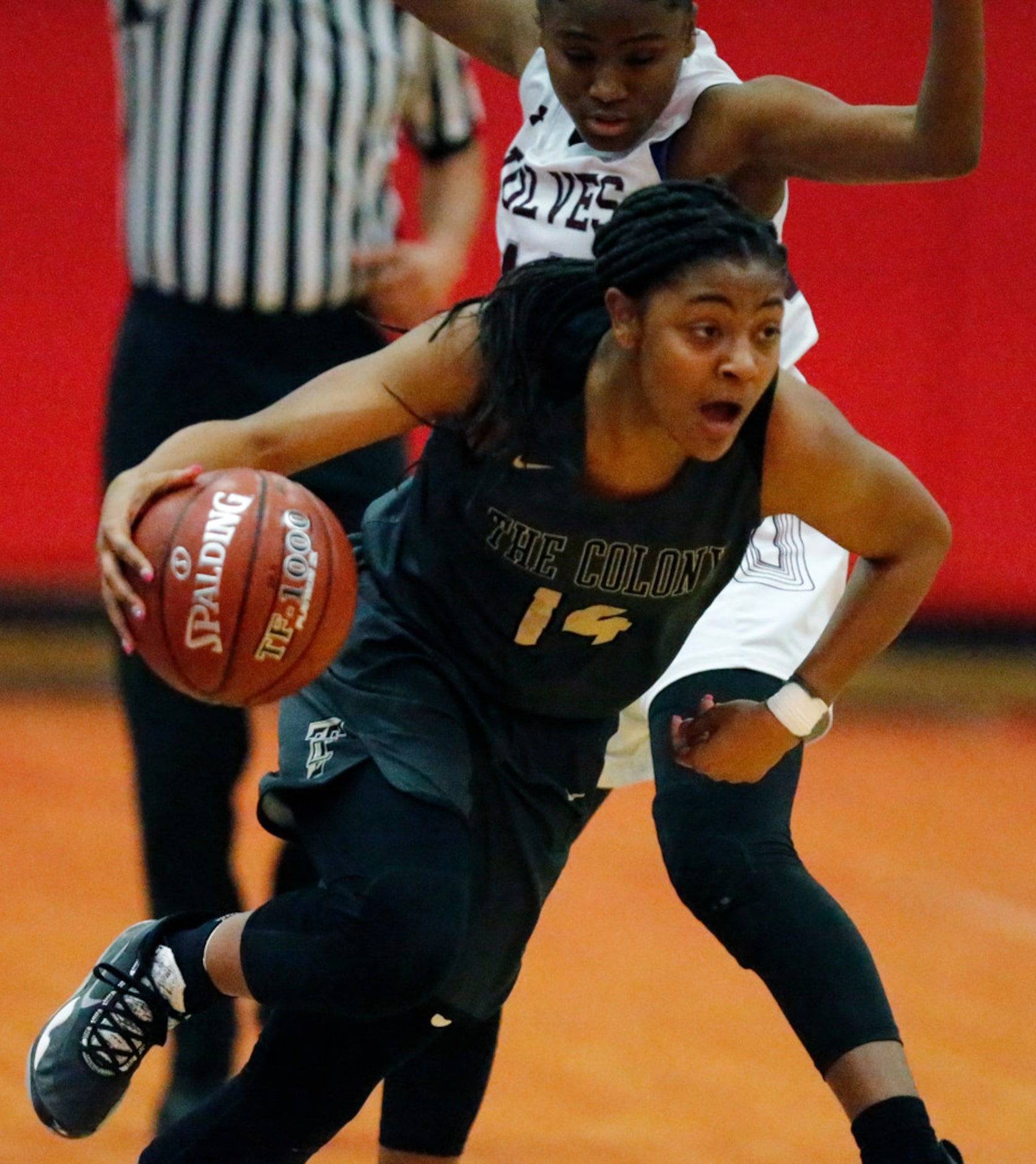 The Colony High School guard Tamia Jones (14) goes around Timberview High School guard Kyia...