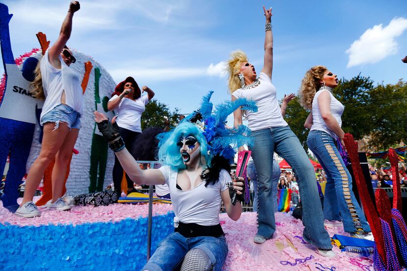 Revelers on a float dance and perform on the AVEN float during the Alan Ross Texas Freedom...