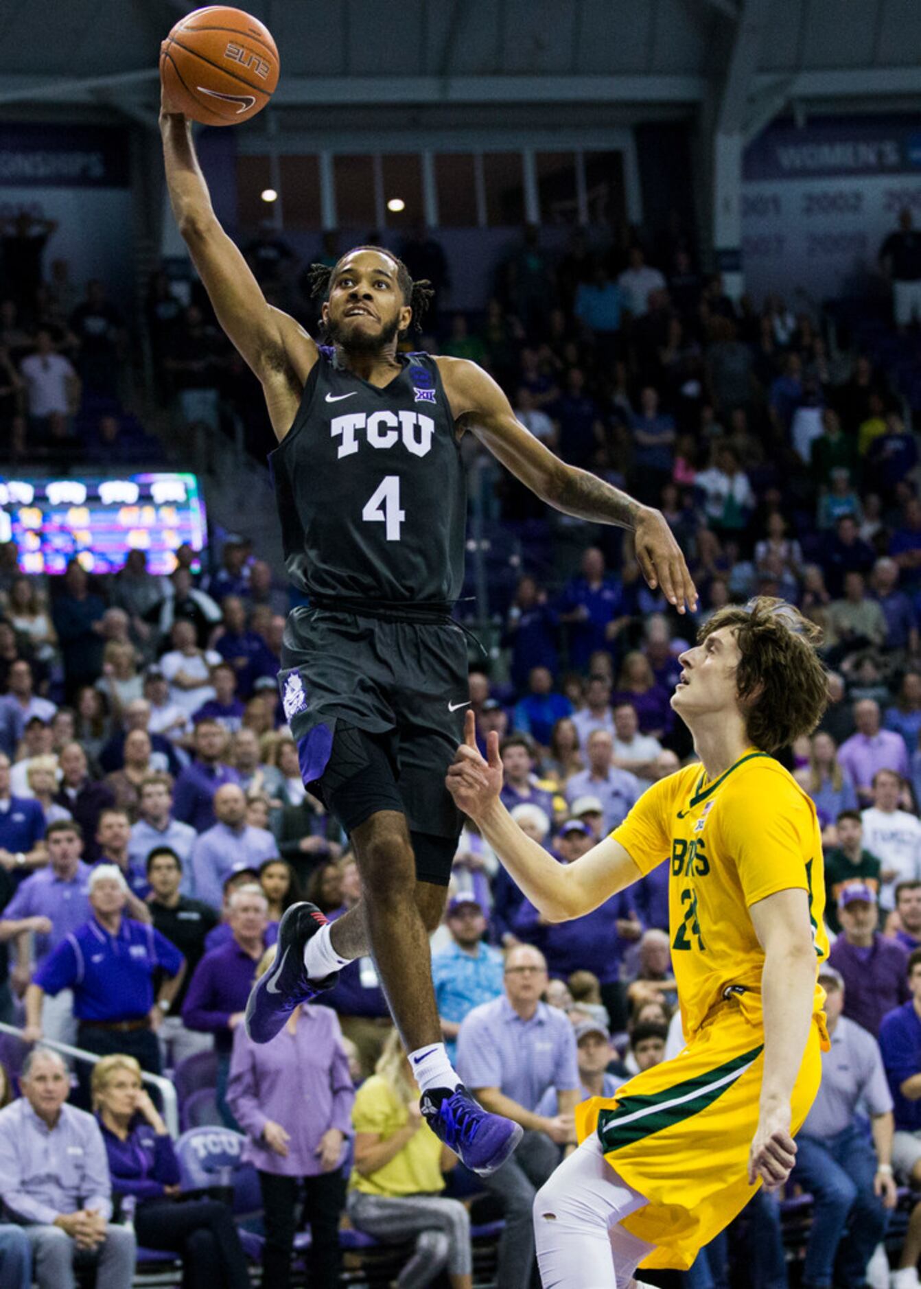 TCU Horned Frogs guard PJ Fuller (4) goes up for a dunk over Baylor Bears guard Matthew...