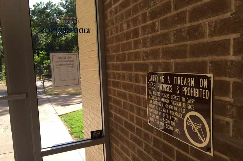  A "no gun" sign at Dallas' Kidd Springs Recreation Center was taken down before a new state...