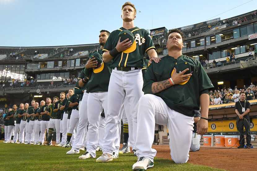 OAKLAND, CA - SEPTEMBER 26:  Bruce Maxwell #13 of the Oakland Athletics kneels in protest...