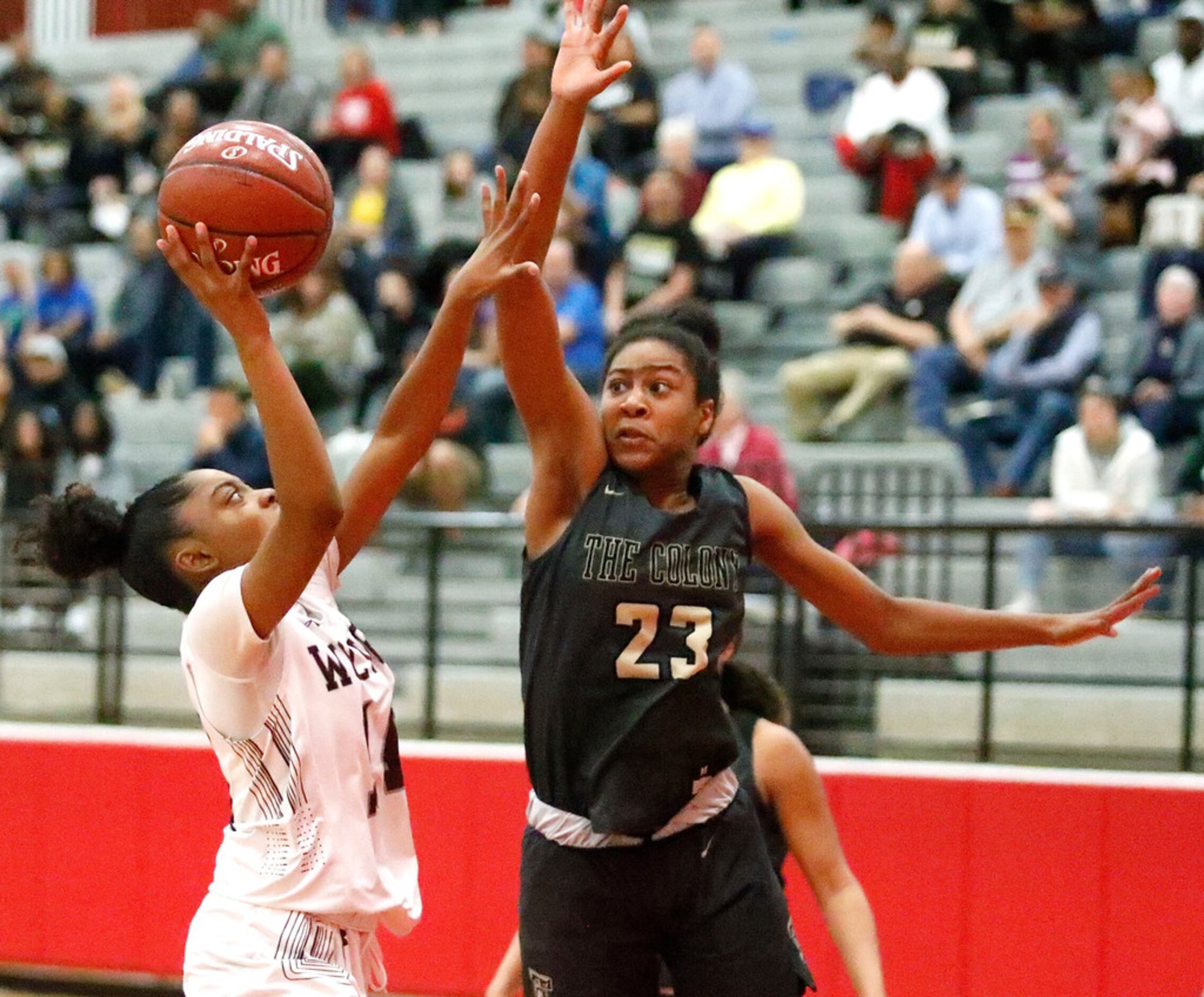 Timberview High School guard Kayla Proctor (14) puts up a shot as The Colony High School...