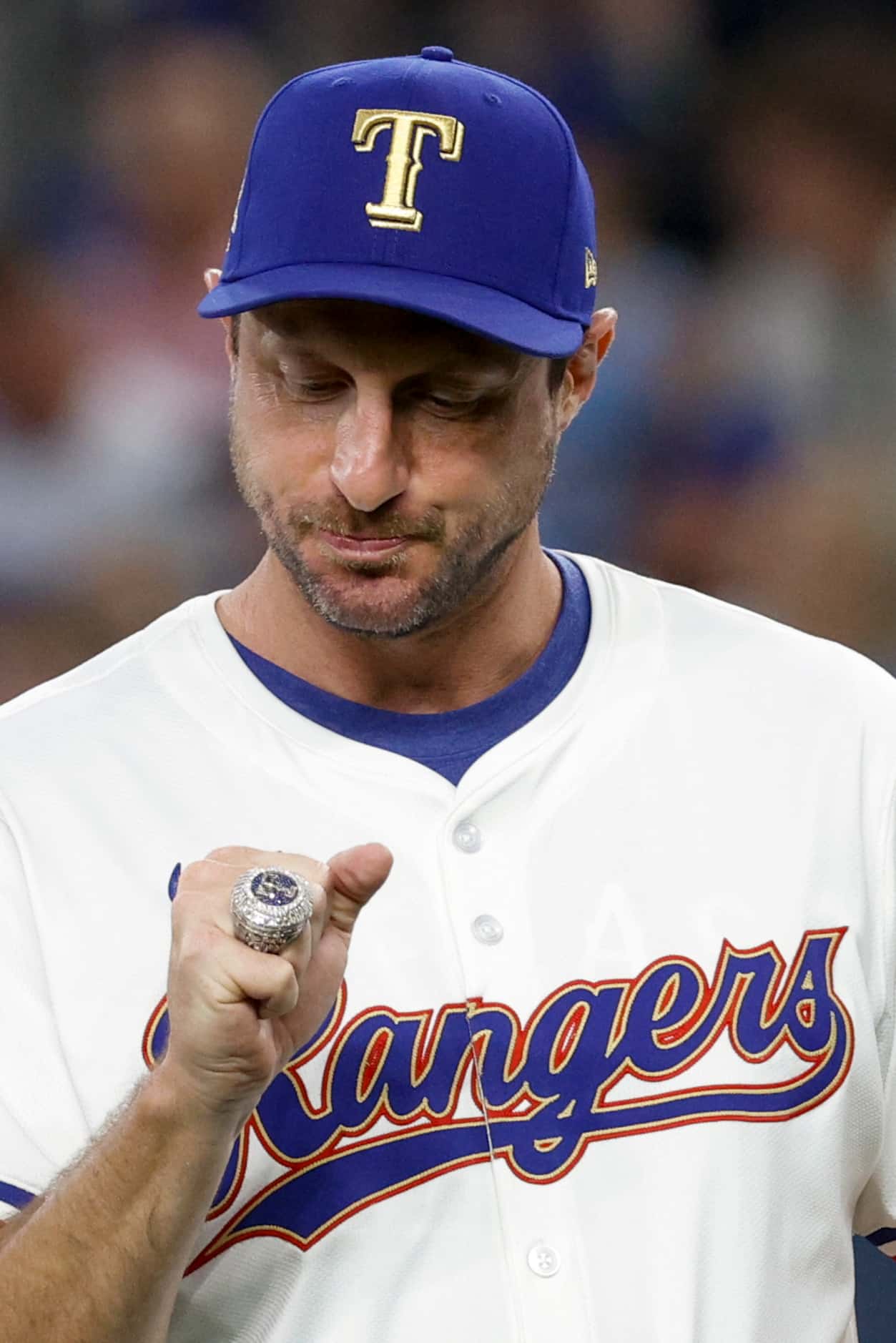 Texas Rangers starting pitcher Max Scherzer checks out his World Series championship ring...