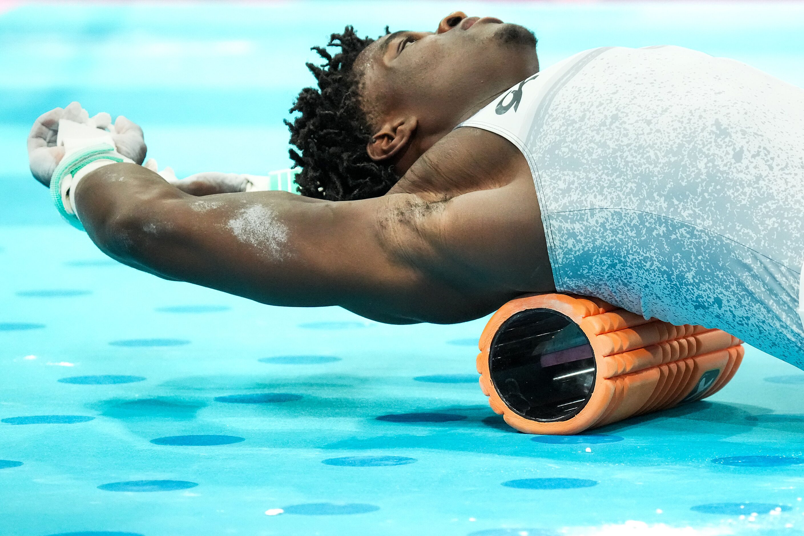 Frederick Richard of the United States stretches during gymnastics podium training ahead of...