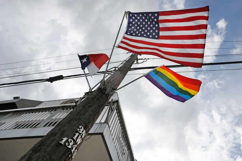 Flags fly at the intersection of Cedar Springs Road and Throckmorton Street in Dallas.