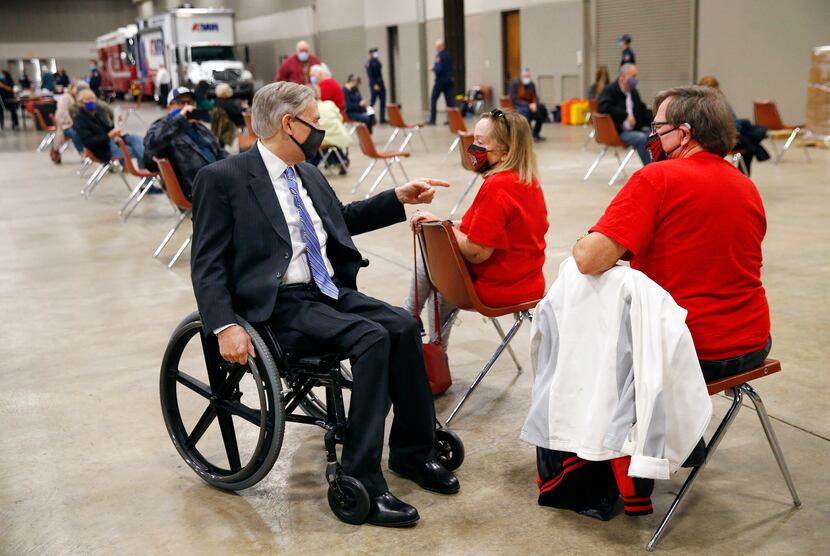 Texas Governor Greg Abbott (left visits with Michael and Sara Cramer of Arlington in a...