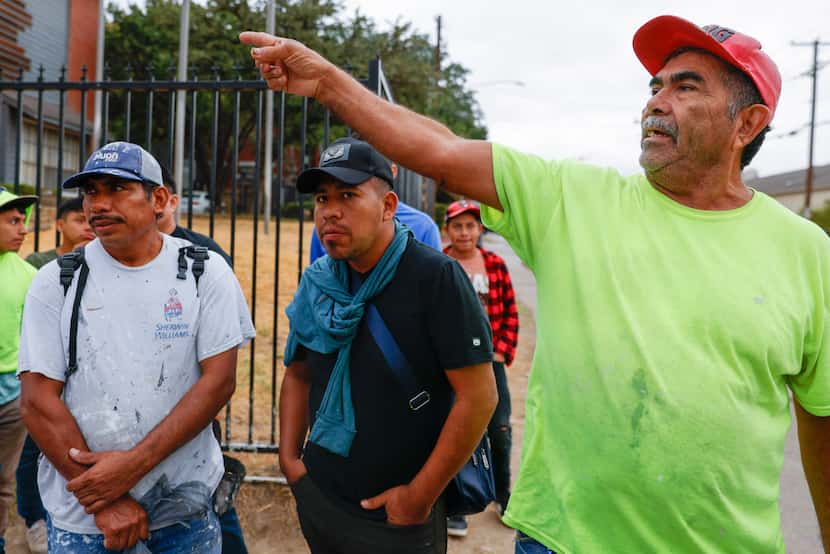 José Antonio, (right) 62, from Honduras, shares his experience as he waits to get hired for...