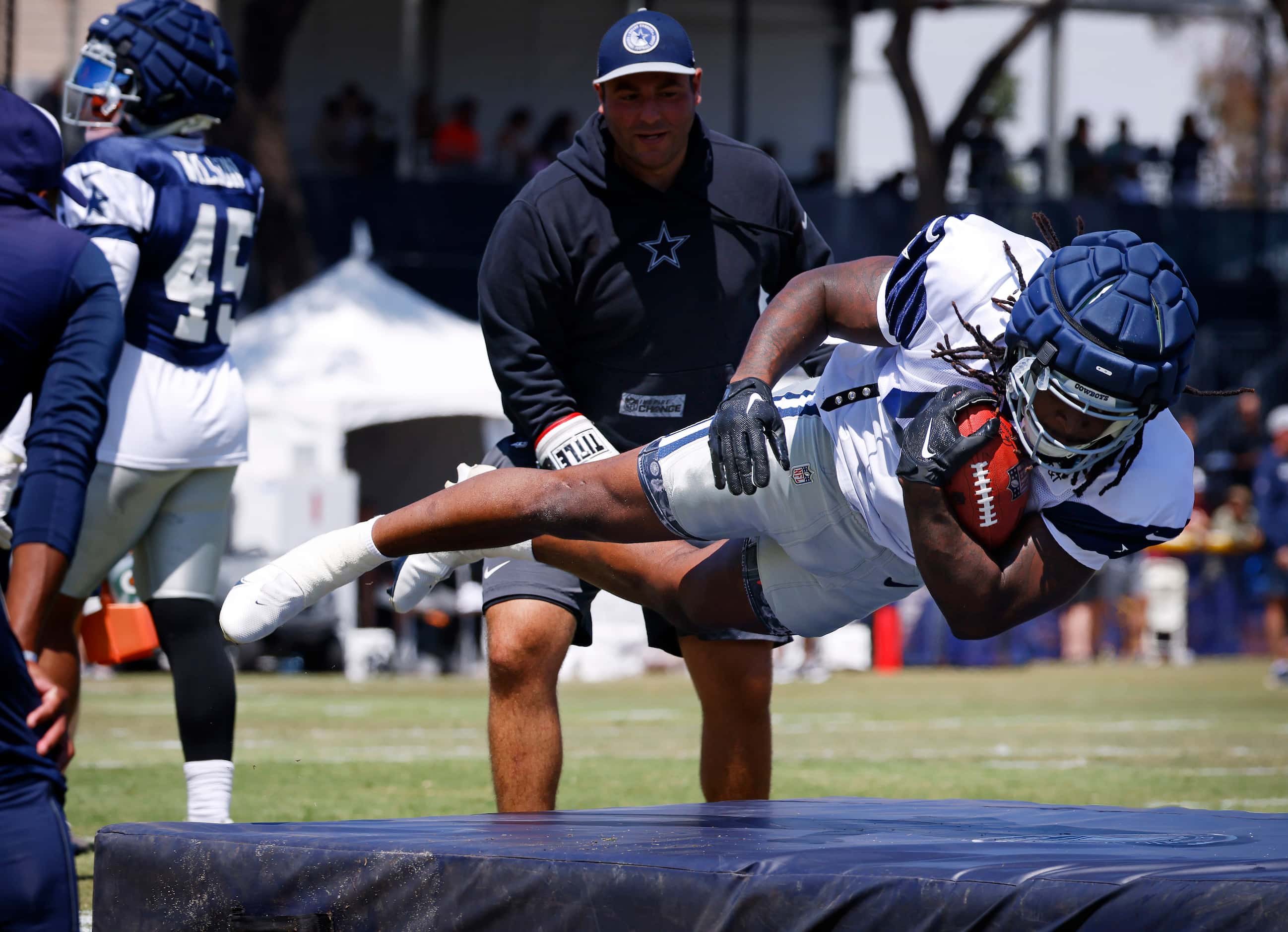 Dallas Cowboys tight end Princeton Fant (48) dives onto a mat after taking boxing shots to...