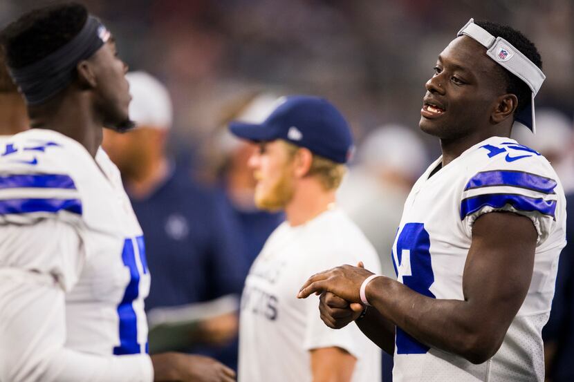 Dallas Cowboys wide receiver Michael Gallup (13) talks to wide receiver Allen Hurns (17) on...