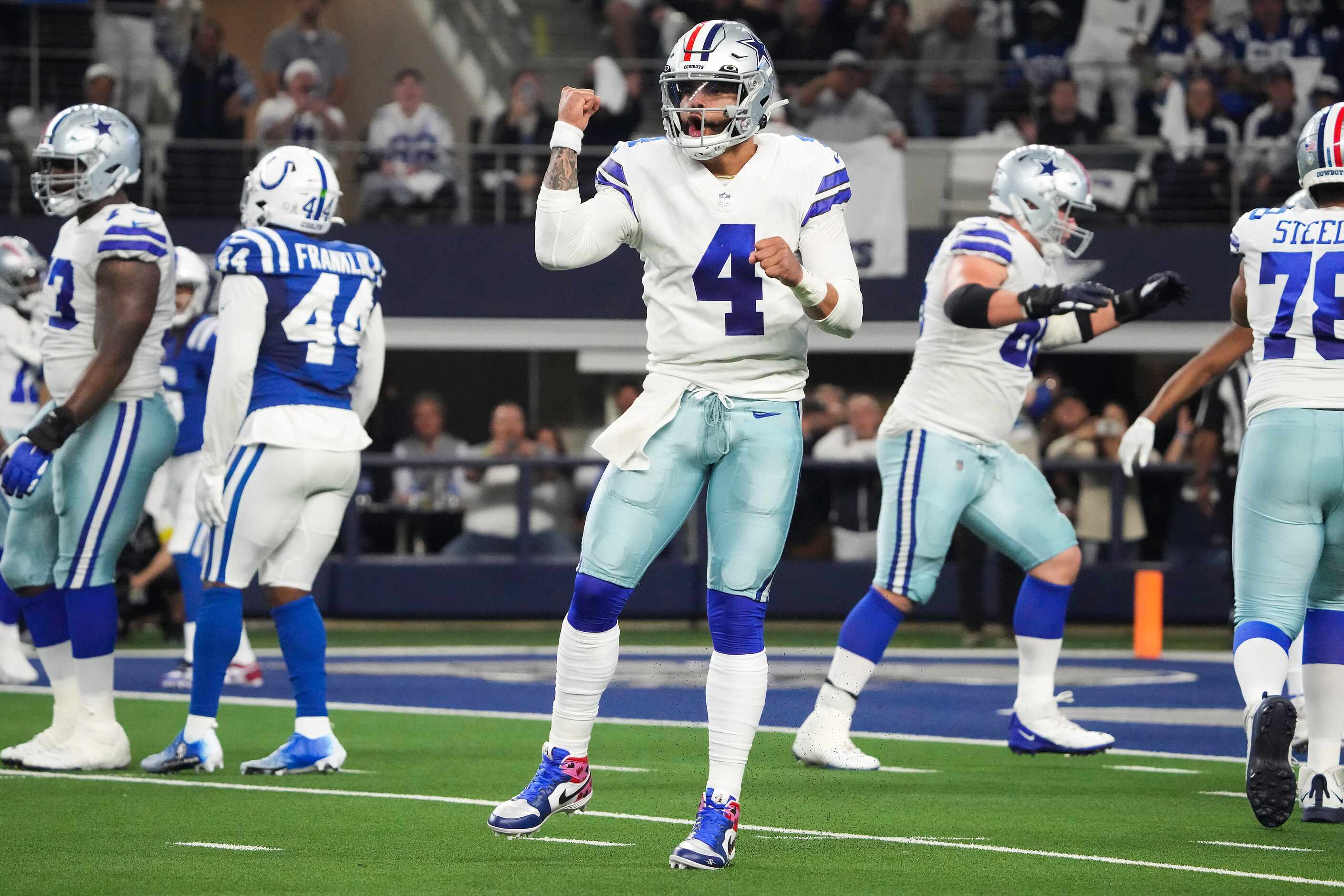 Dallas Cowboys quarterback Dak Prescott (4) celebrates a touchdown run by running back Tony...