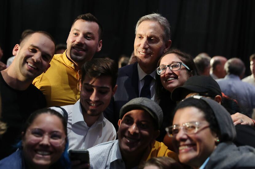 Former Starbucks CEO Howard Schultz poses with people during a stop at Miami Dade College as...