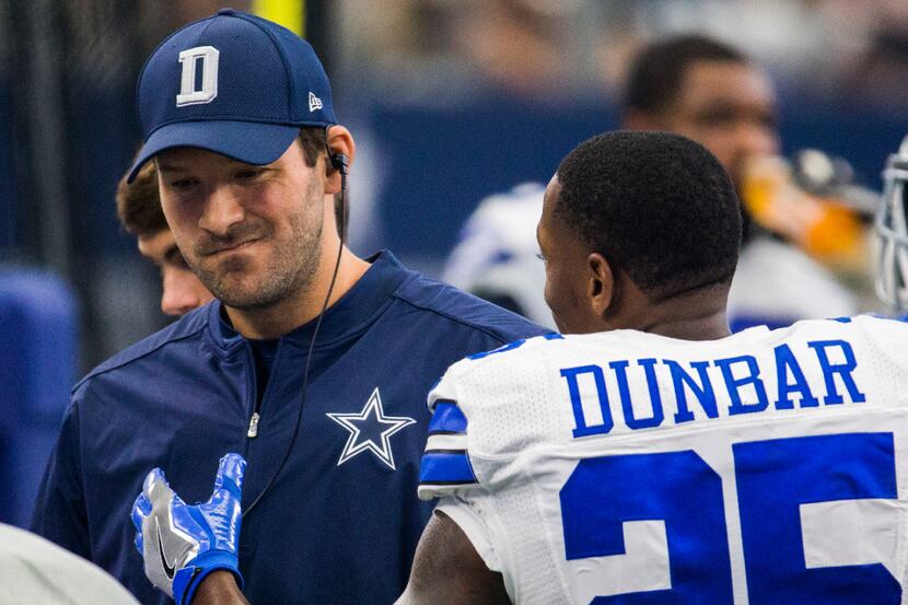 Dallas Cowboys quarterback Tony Romo (9) gets a pat on the chest from running back Lance...