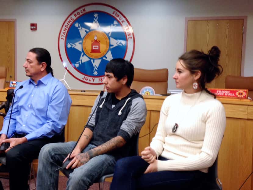 Standing Rock Sioux Chairman Dave Archambault (left), tribal youth Garrett Hairychin and...