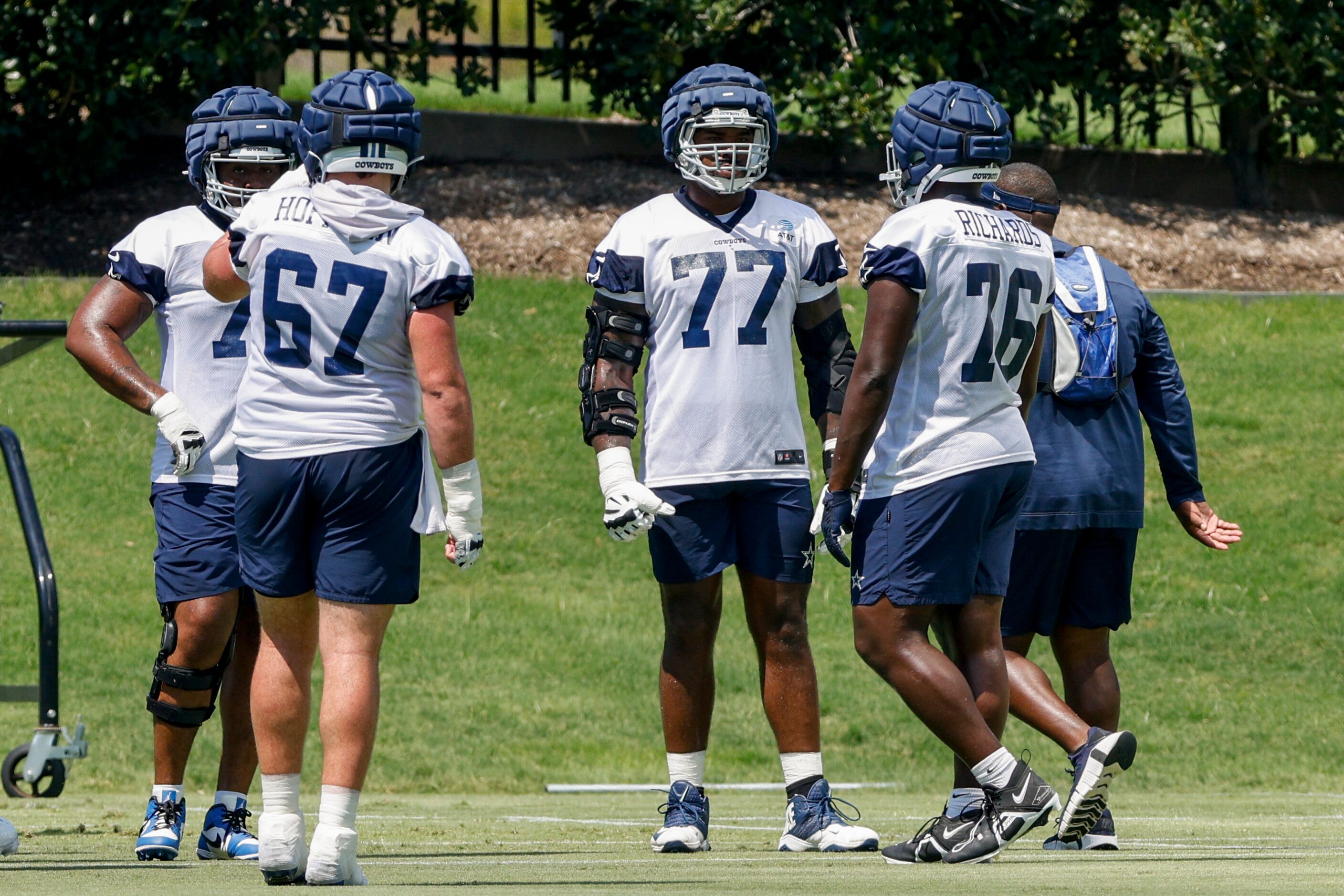 Dallas Cowboys tackle Tyron Smith (77) talks with tackle Asim Richards (76) and center Brock...