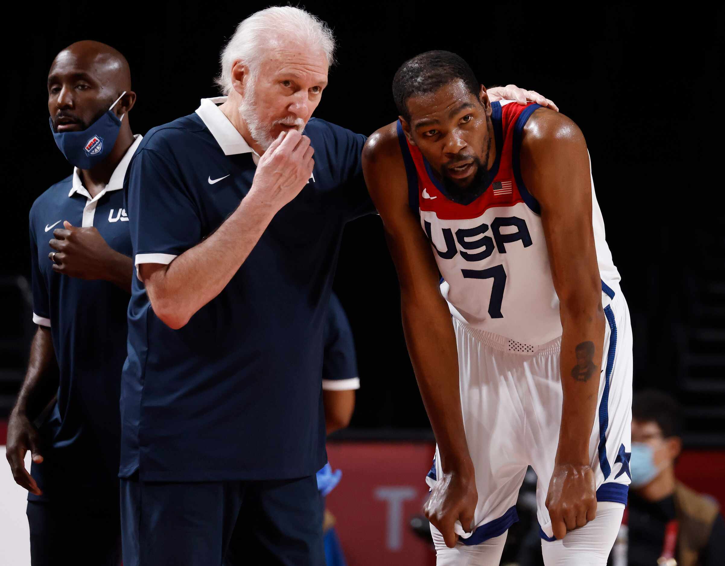 USA’s head coach Gregg Popovich talks to Kevin Durant (7) during a break in play against...