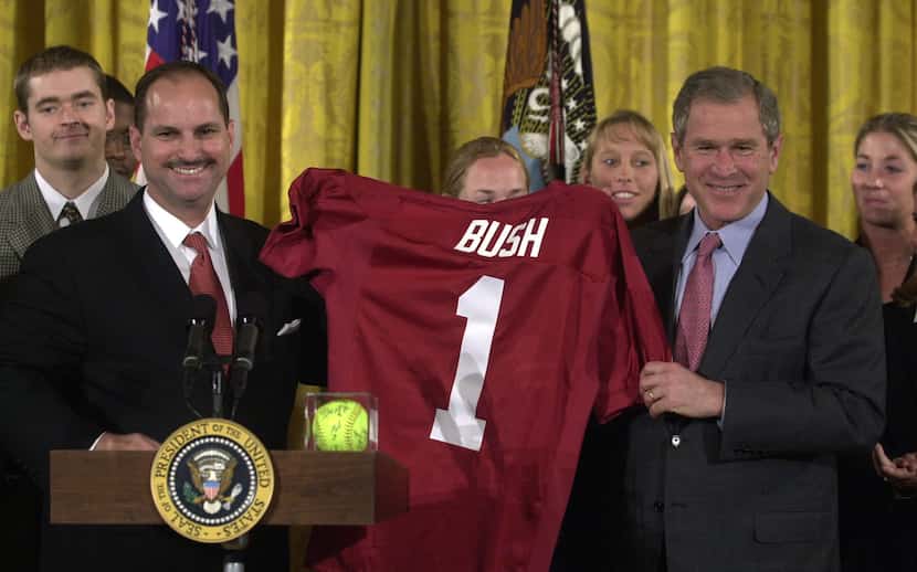 President Bush, right, is presented a football jersey from University of Oklahoma athletic...