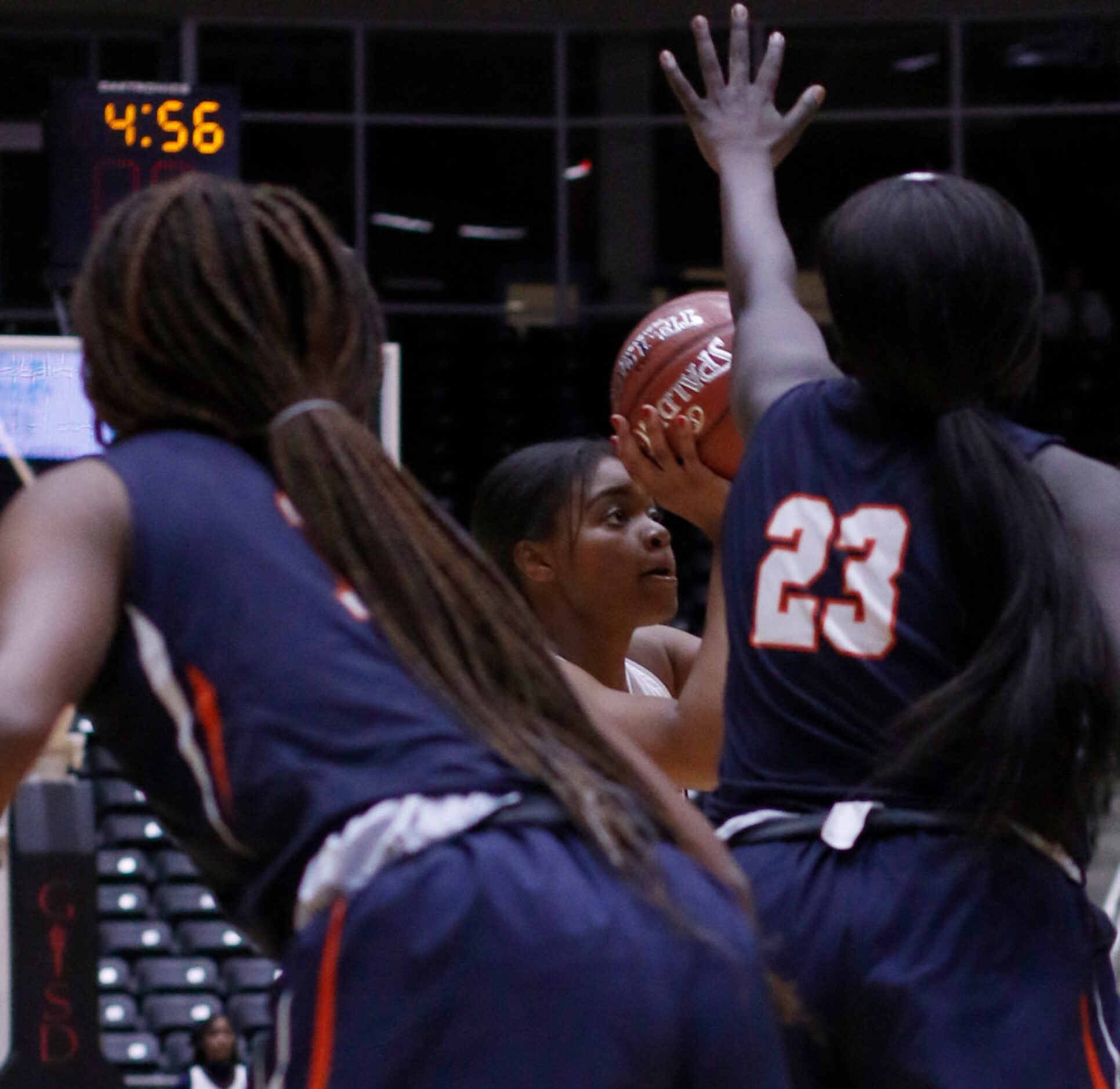 Allen guard Nyah Green (31) eyes a shot between the defense of Sachse post Adhel Tac (23)...