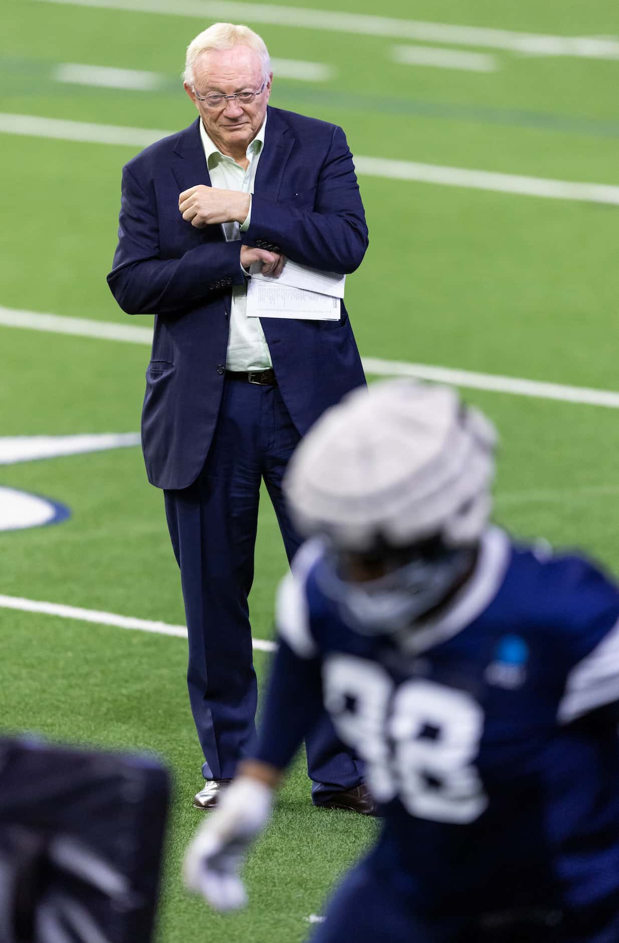Dallas Cowboys owner Jerry Jones watches as defensive tackle Quinton Bohanna runs a drill...