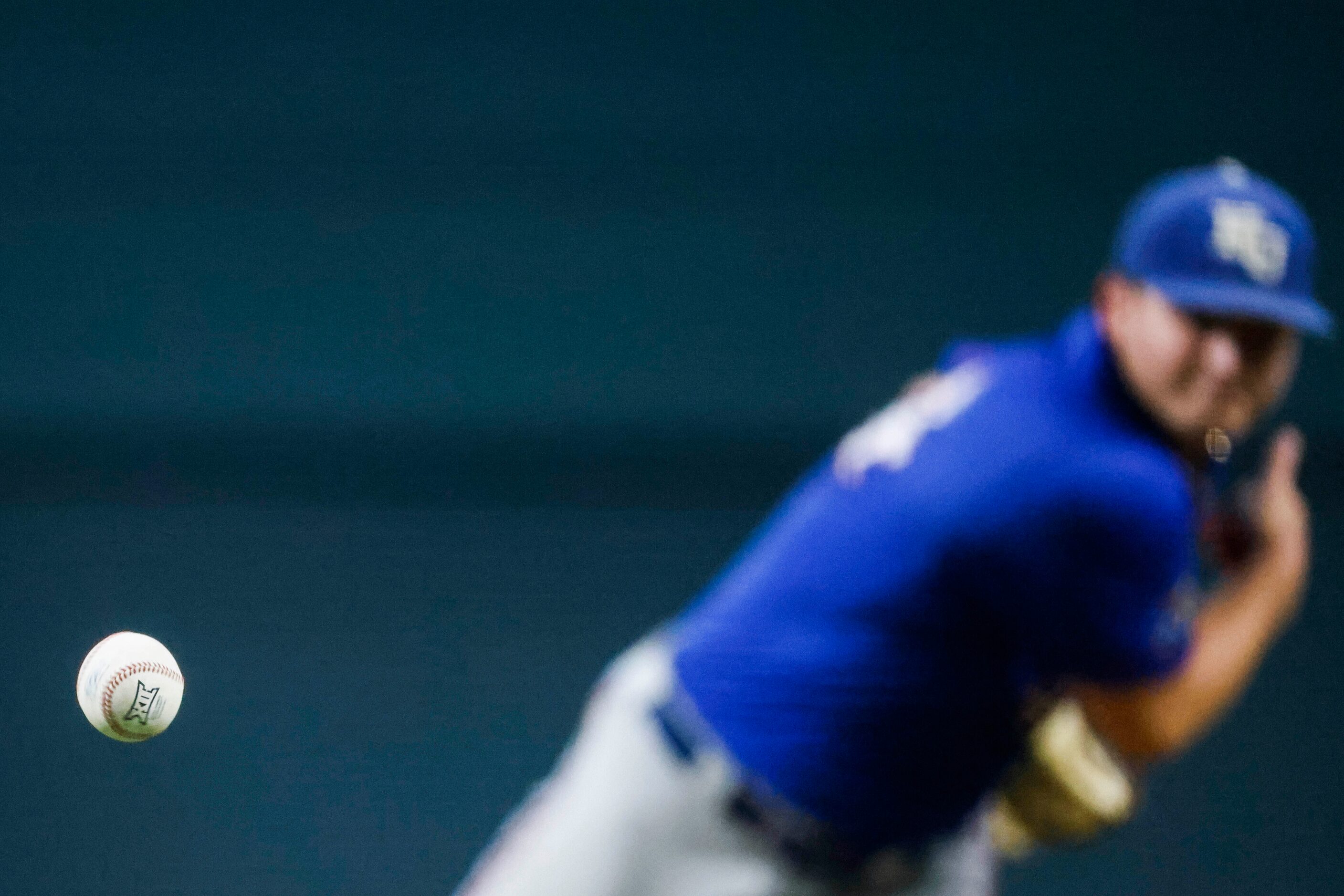 Kansas pitcher Kolby Dougan throws during the fourth inning of a baseball game against...