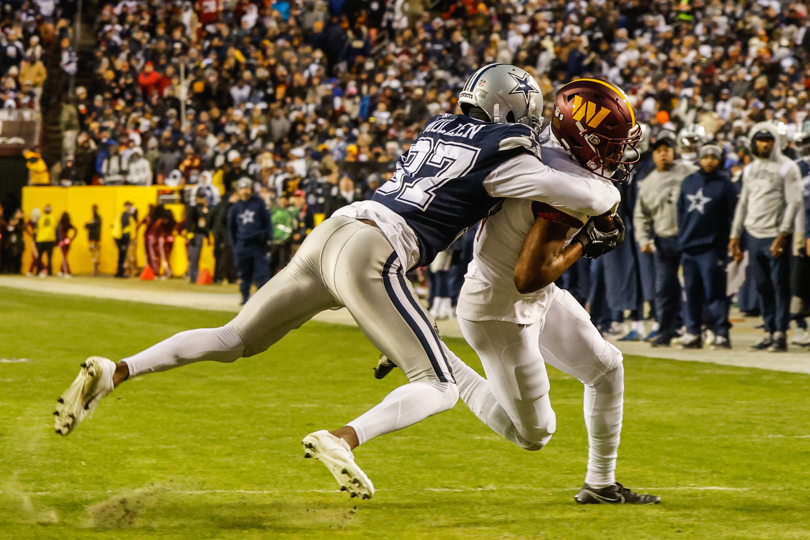 Dallas Cowboys cornerback Trayvon Mullen (37) tackles Washington Commanders wide receiver...