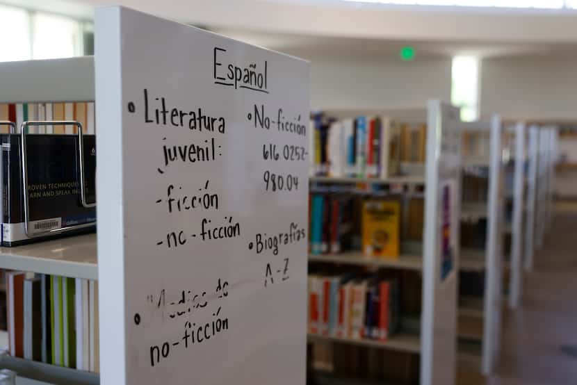 Signs in Spanish on the bookshelves of Vickery Meadow Library on  Friday, April 21, 2023 in...