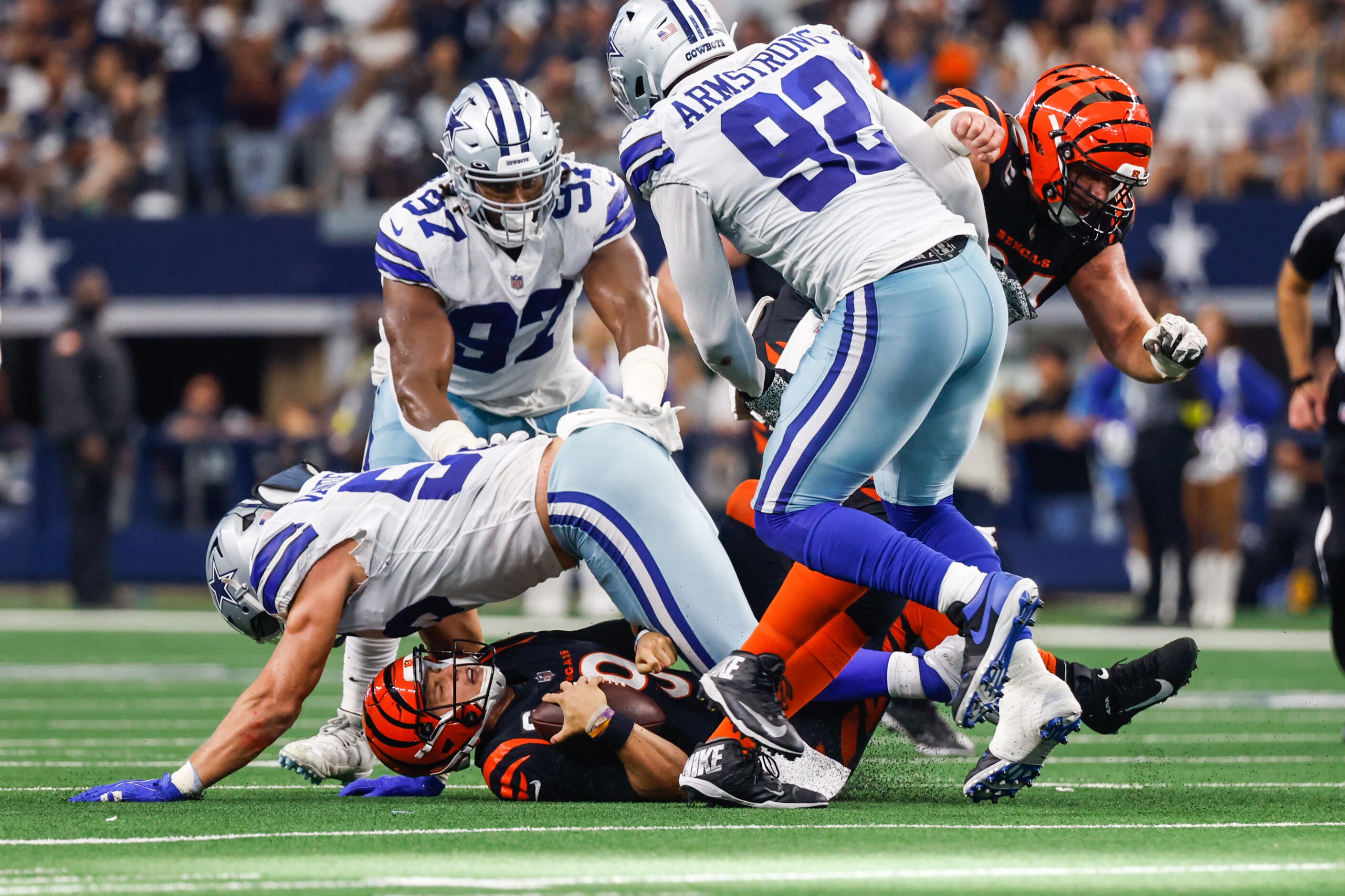 Cincinnati Bengals quarterback Joe Burrow (9) gets sack by Dallas Cowboys linebacker...