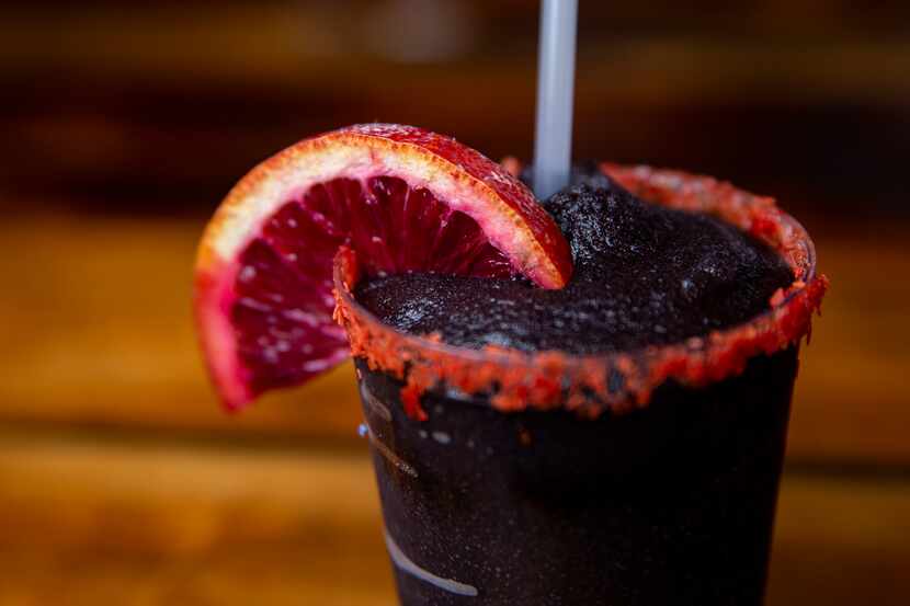 The black frozen margarita at Terry Black's Barbecue in Dallas is made with with tequila,...